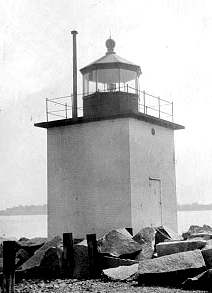 Before: low-resolution photo of a small harbor lighthouse